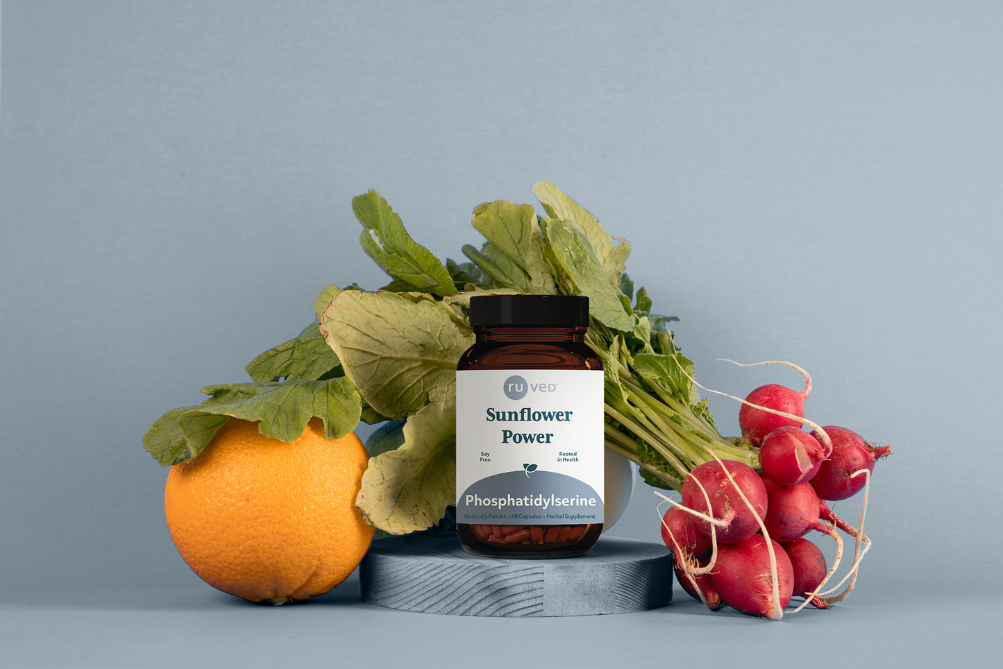 Phosphatidylserine Bottle sitting on a podium with vegetables behind it.