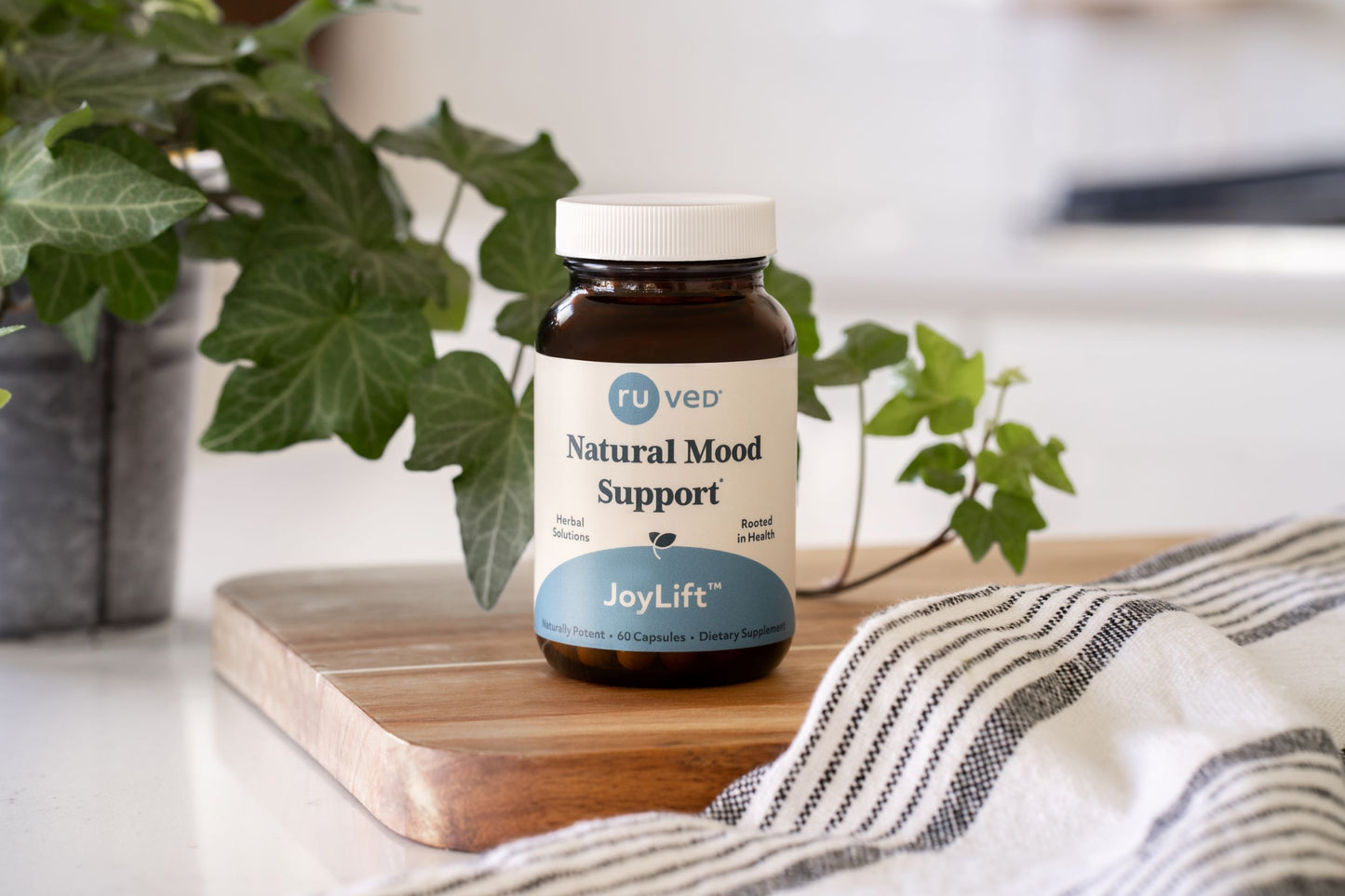 A bottle of JoyLift sitting on a cutting board.