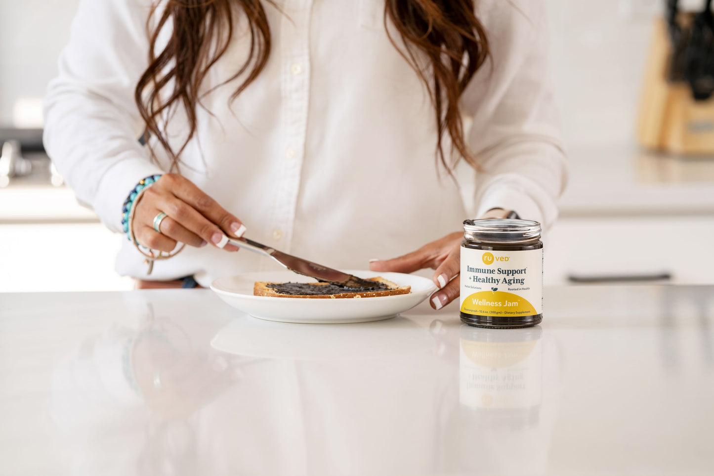 Wellness Jam being spread on toast