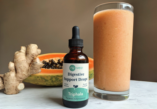 Ruved digestive support drops next to a tropical digestive smoothie. 