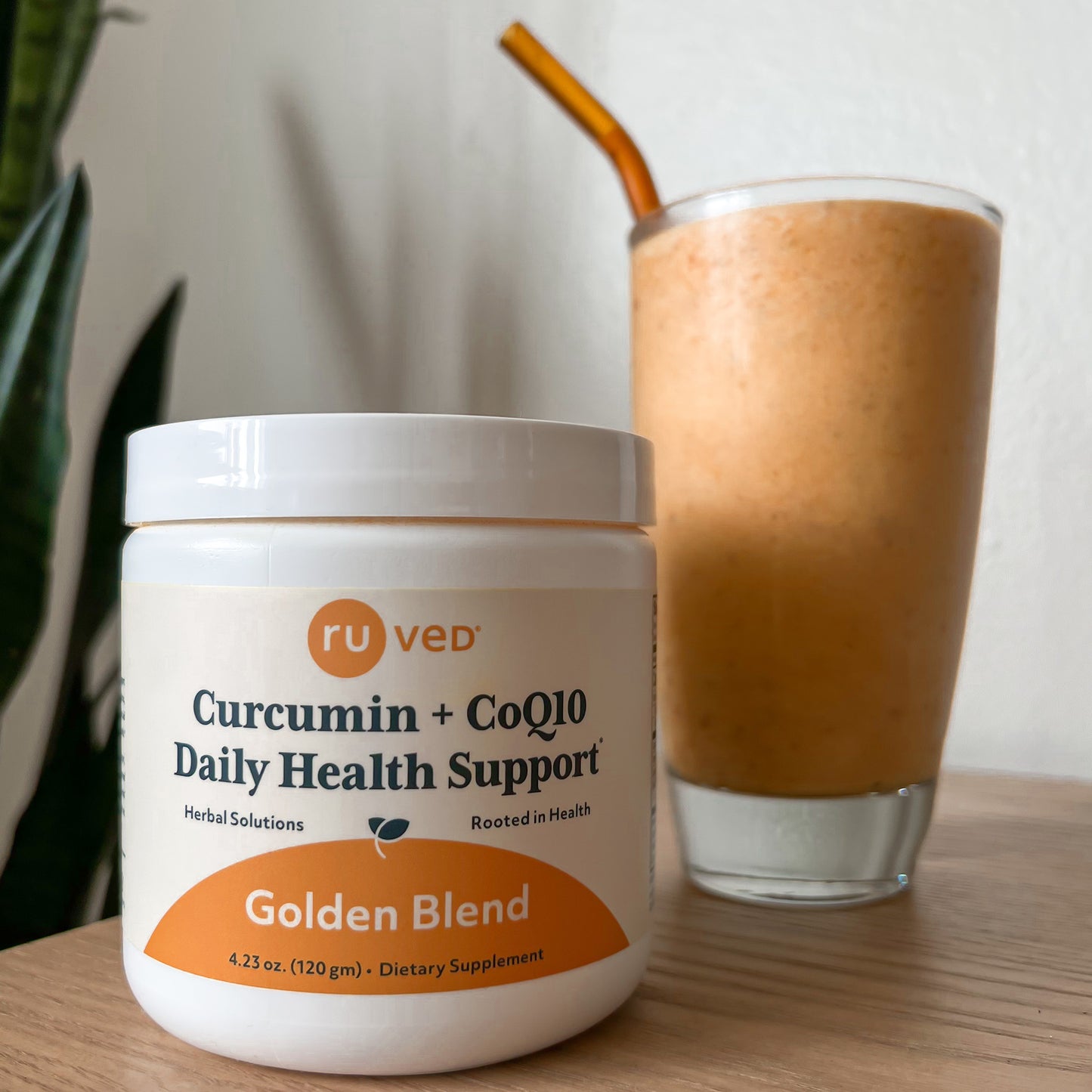 Glass jar of Cocurcumin beside a protein shake, highlighting health and wellness supplements.