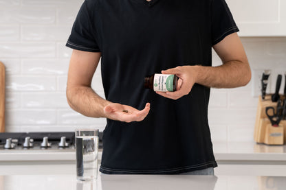 A person pouring a capsule into their hand from Livtone.