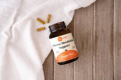 Sugar Nix sitting near its capsules on wood with a towel. 
